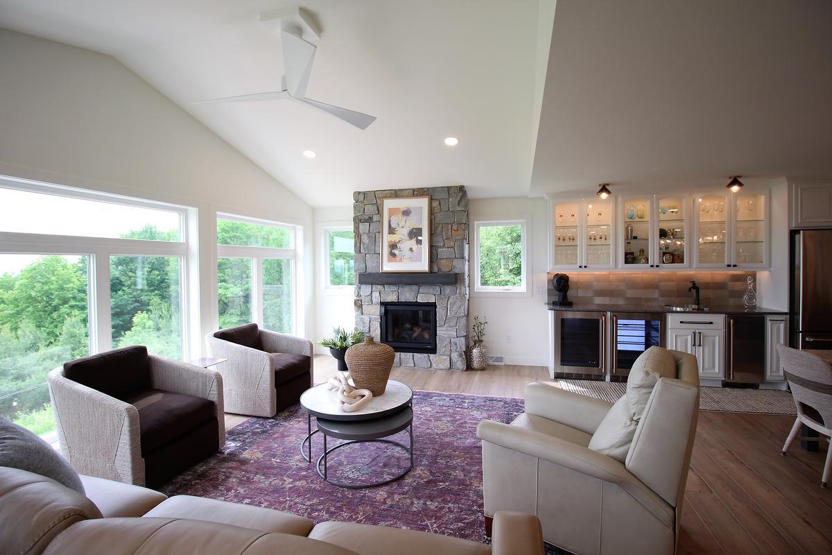 Cozy living room with fireplace and scenic windows in a Ross Construction custom home in Wausau, WI.