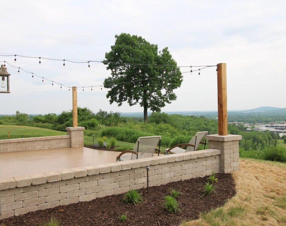 Custom outdoor seating area with string lights and panoramic backdrop in Rib Mountain, WI by Ross Construction