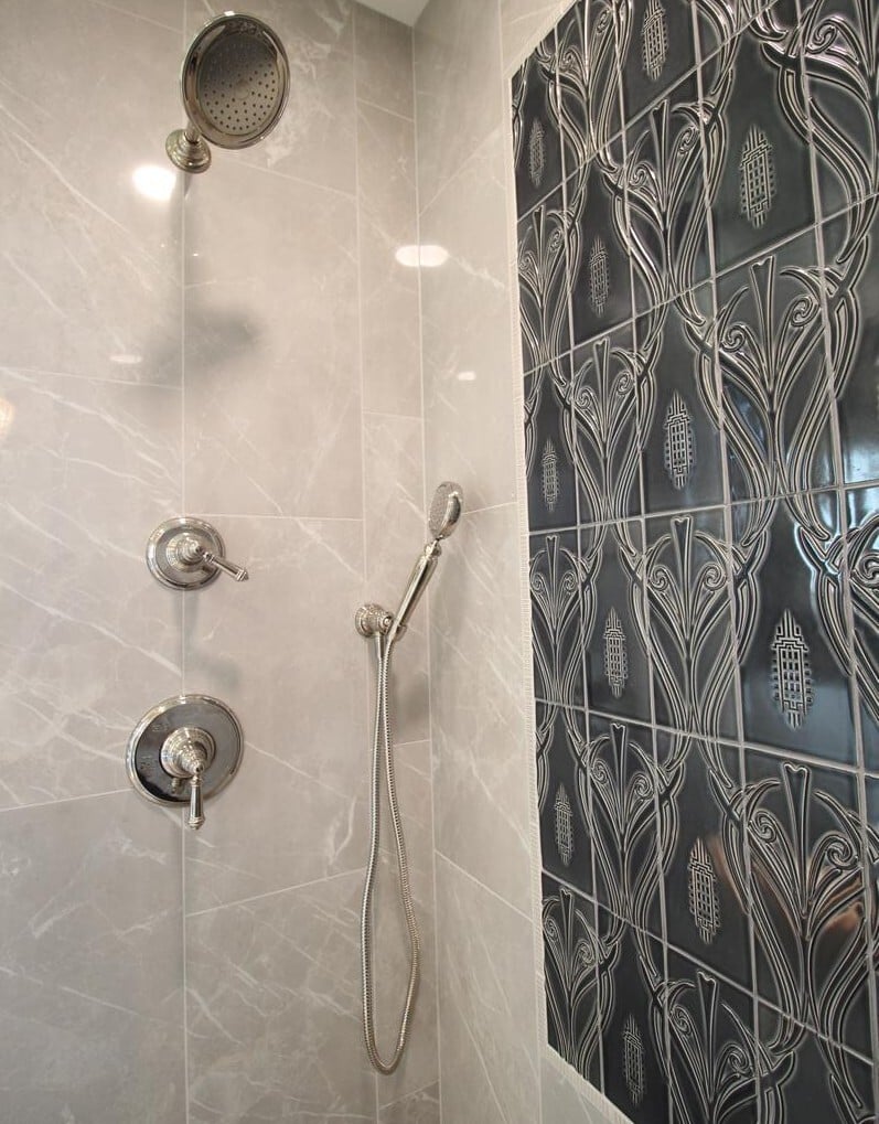 Luxurious walk-in shower with ornate tile accent by Ross Construction in a custom home in Wausau, WI.