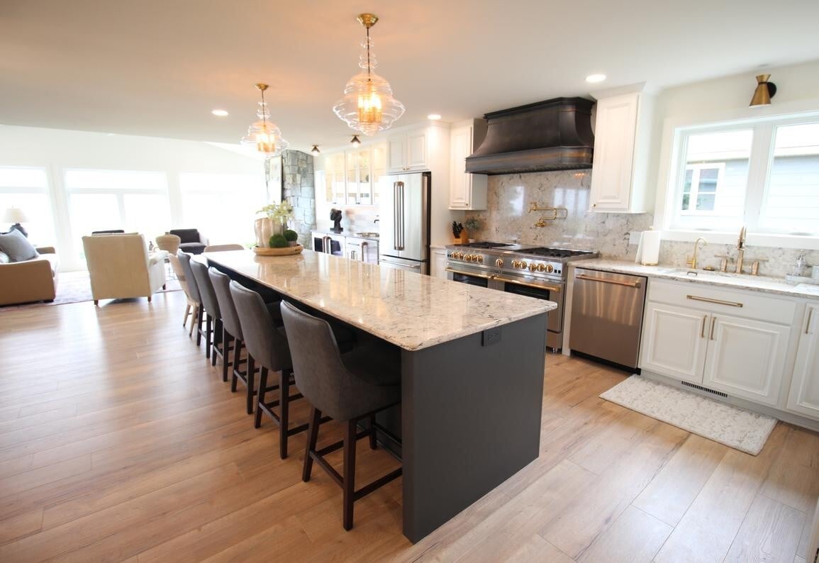 Luxury kitchen design by Ross Construction featuring quartz countertops and stainless appliances in Lake Dubay, WI.