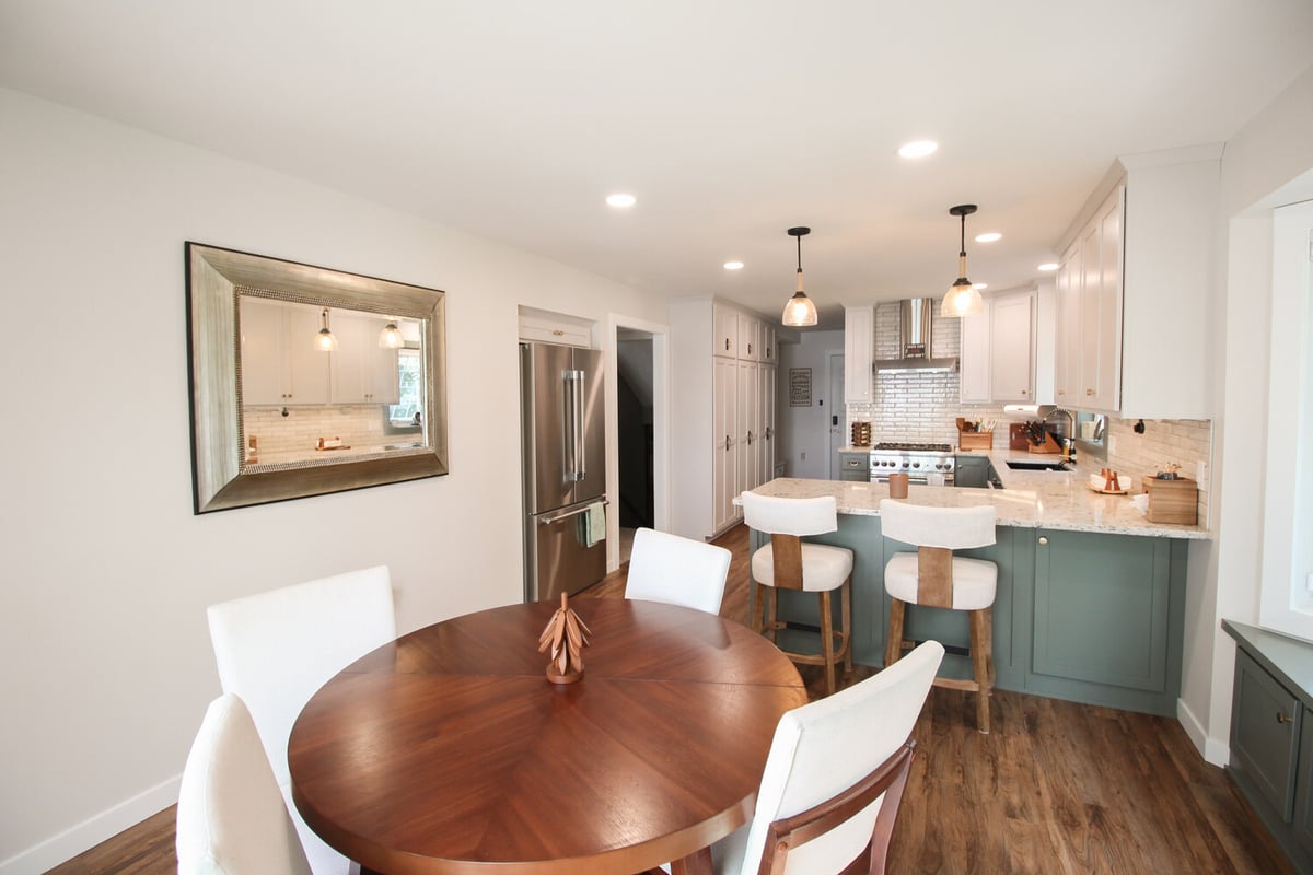 Dining and kitchen area in Marathon custom home by Ross Construction with modern pendant lighting.