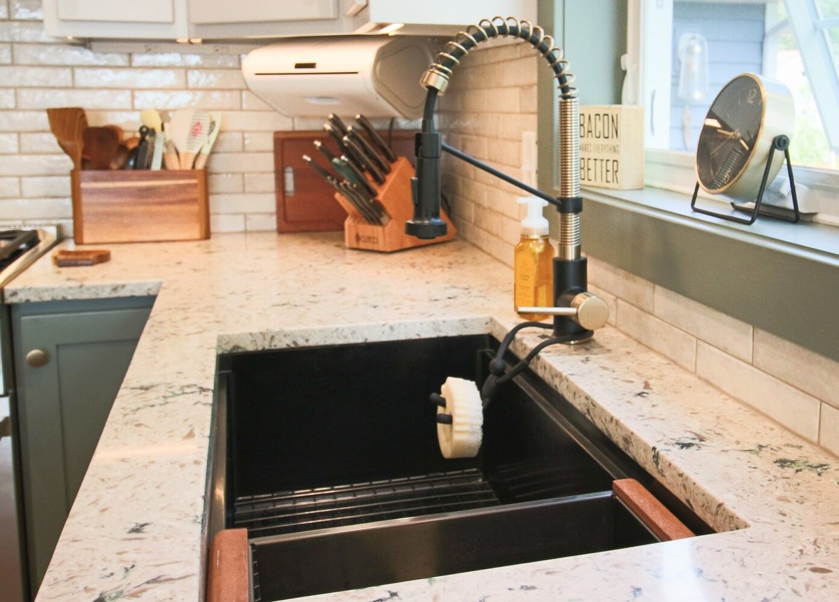 Matte black kitchen faucet with spring coil neck in Marathon custom kitchen by Ross Construction.