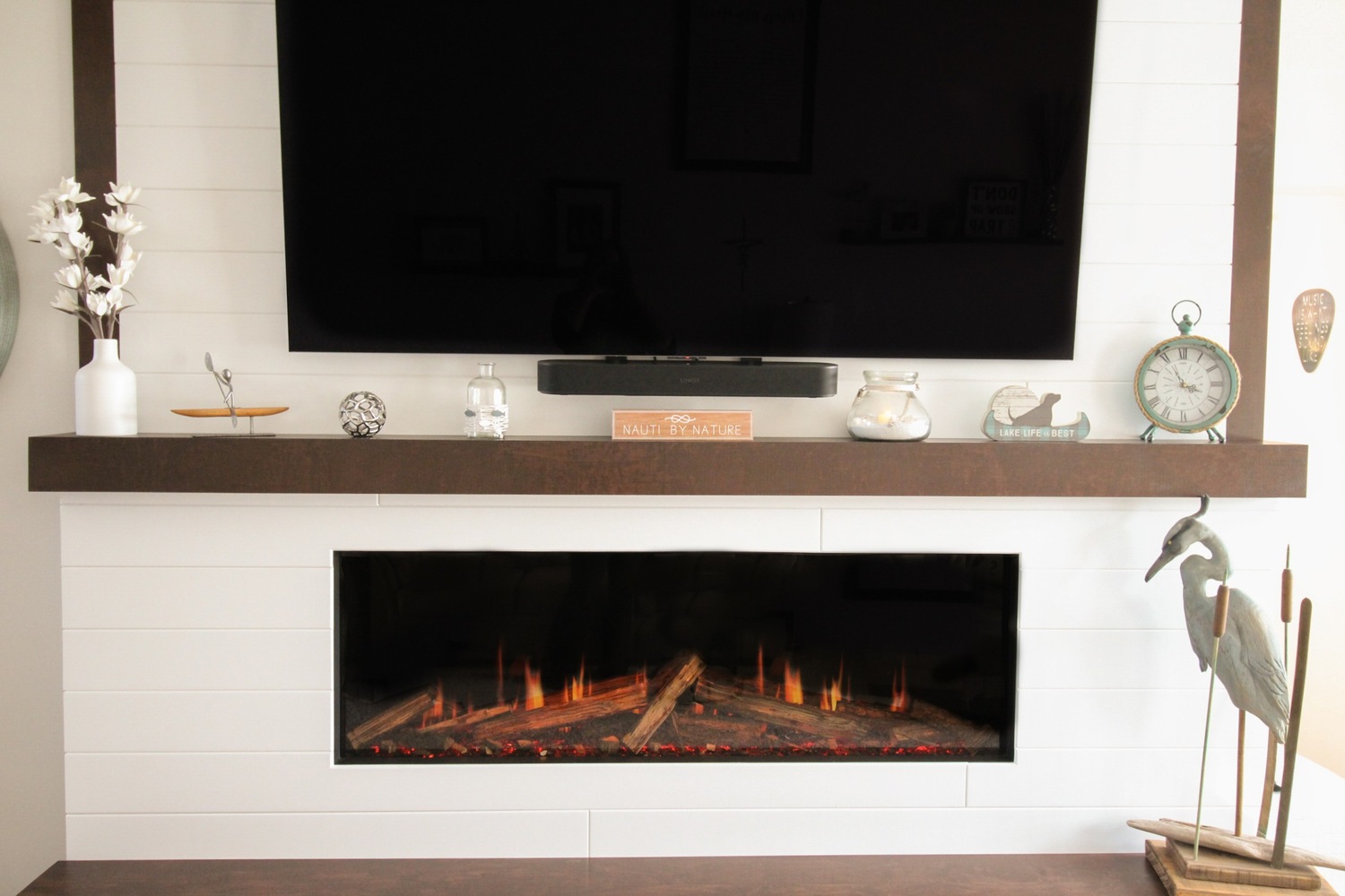 Shiplap fireplace wall with TV and decorative mantel in Marathon custom home by Ross Construction.