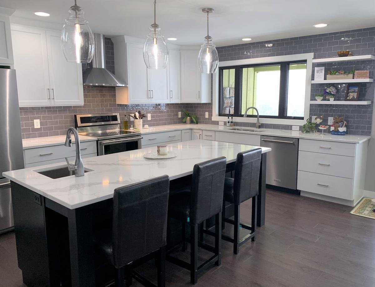Bright kitchen with large island and sleek cabinetry in Marathon custom home by Ross Construction.