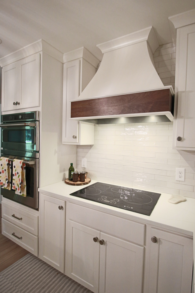Close-up of cooking area with tile backsplash in a custom home kitchen by Ross Construction in Wausau, WI.