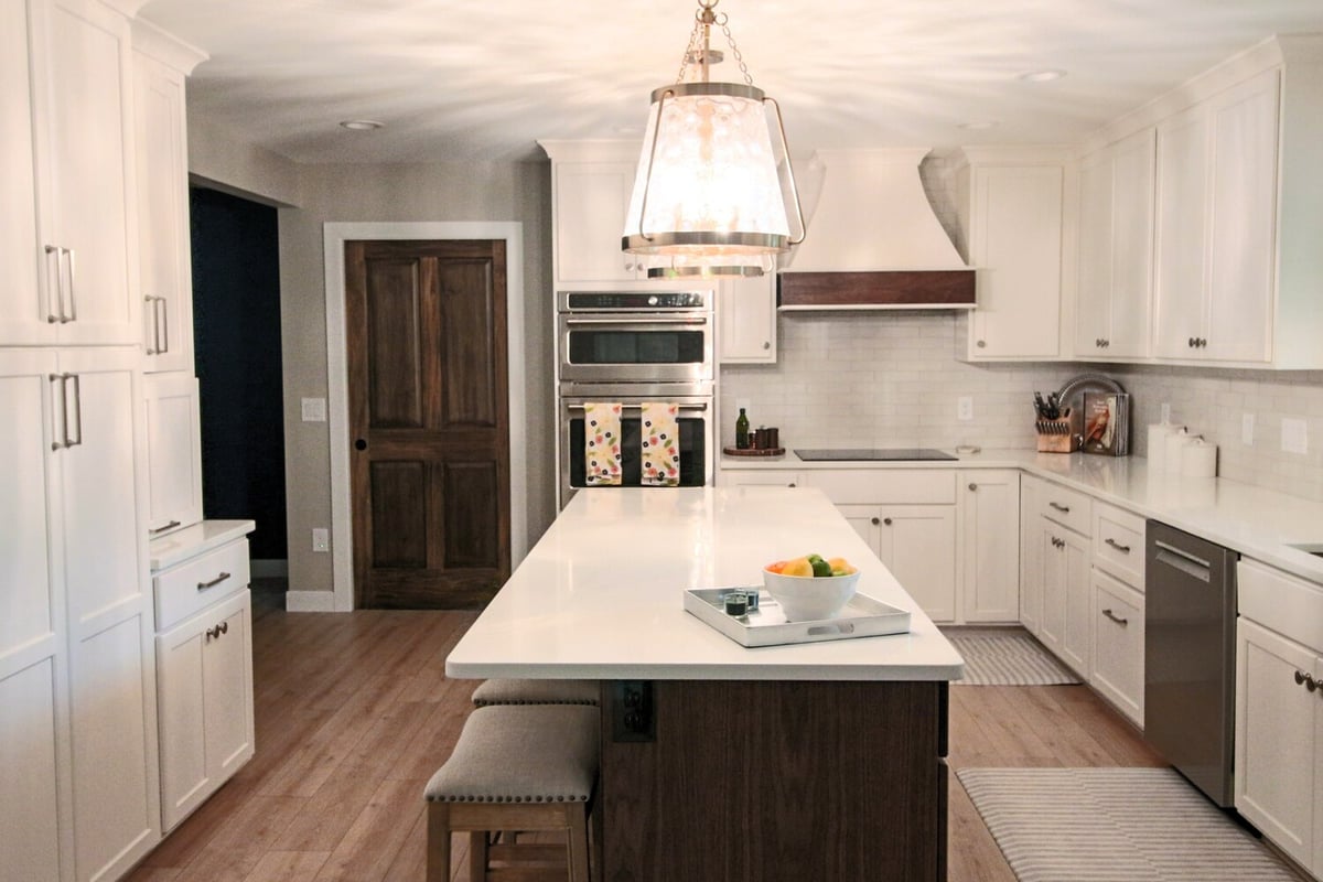 Ross Construction kitchen remodel featuring white shaker cabinets and a large center island in Marathon, WI.