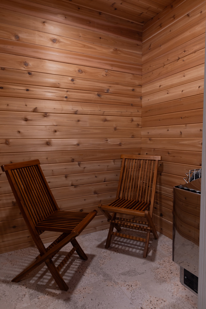 Cedar sauna with folding wood chairs in custom home by Ross Construction in Rib Mountain, WI.