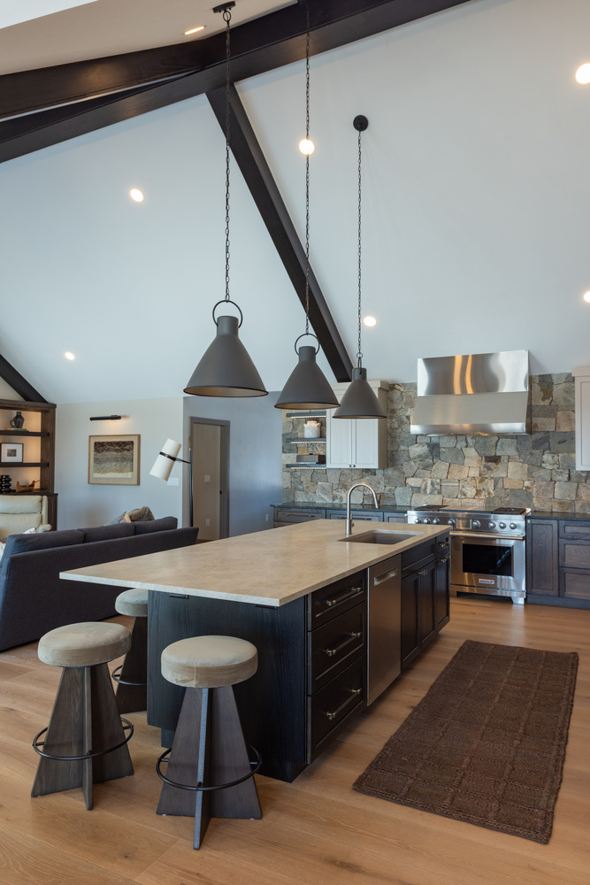 Custom kitchen in Wausau, WI home by Ross Construction featuring oversized island and pendant lighting.
