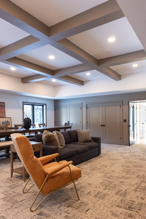 Multipurpose living and dining space with custom coffered ceiling by Ross Construction in Marathon, WI.