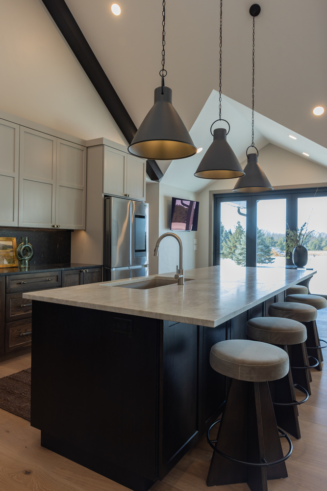 View of kitchen island and pendant lighting in Lake Dubay, WI custom home by Ross Construction.