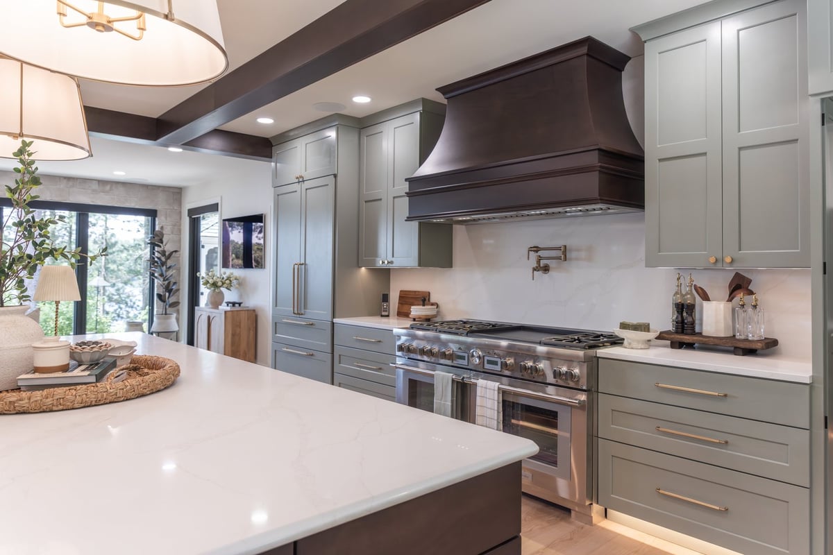 whole home remodel kitchen with sage cabinets and wood range hood minocqua wi