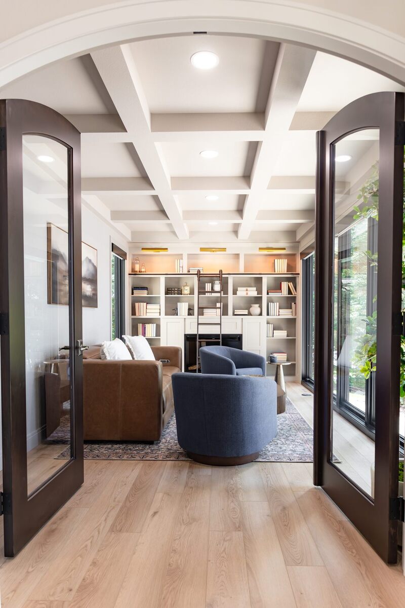 whole home remodel library through arched glass french doors minocqua wi