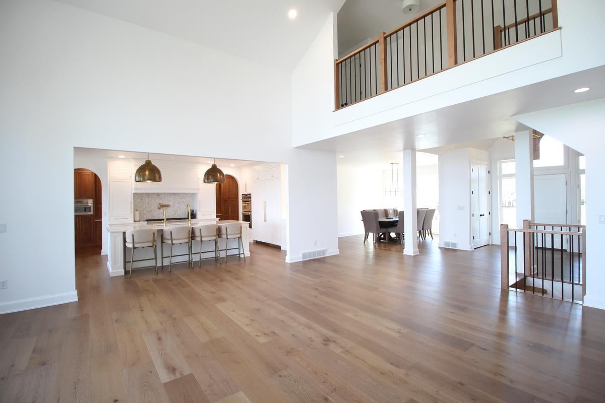 Expansive main floor view featuring kitchen island and dining area by Ross Construction in Wausau, WI.