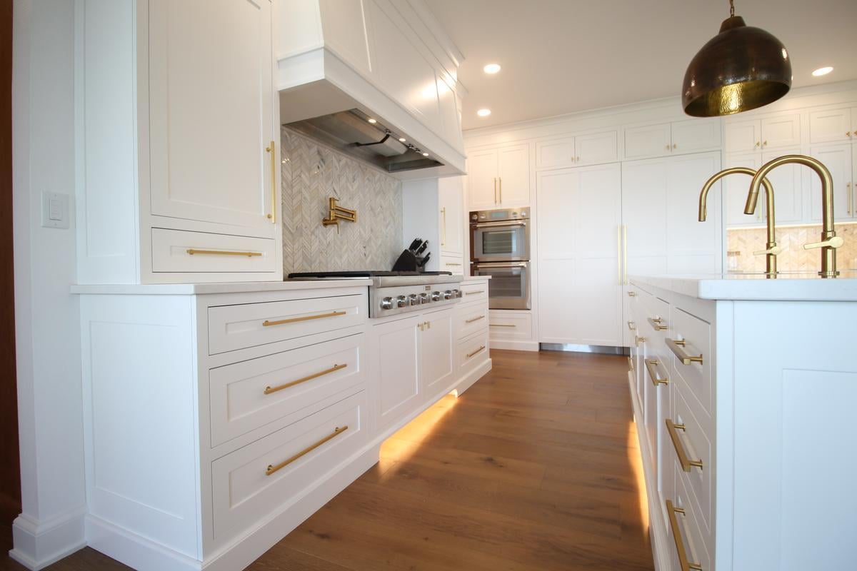 Modern kitchen workspace with herringbone backsplash in Ross Construction home in Rib Mountain, WI.