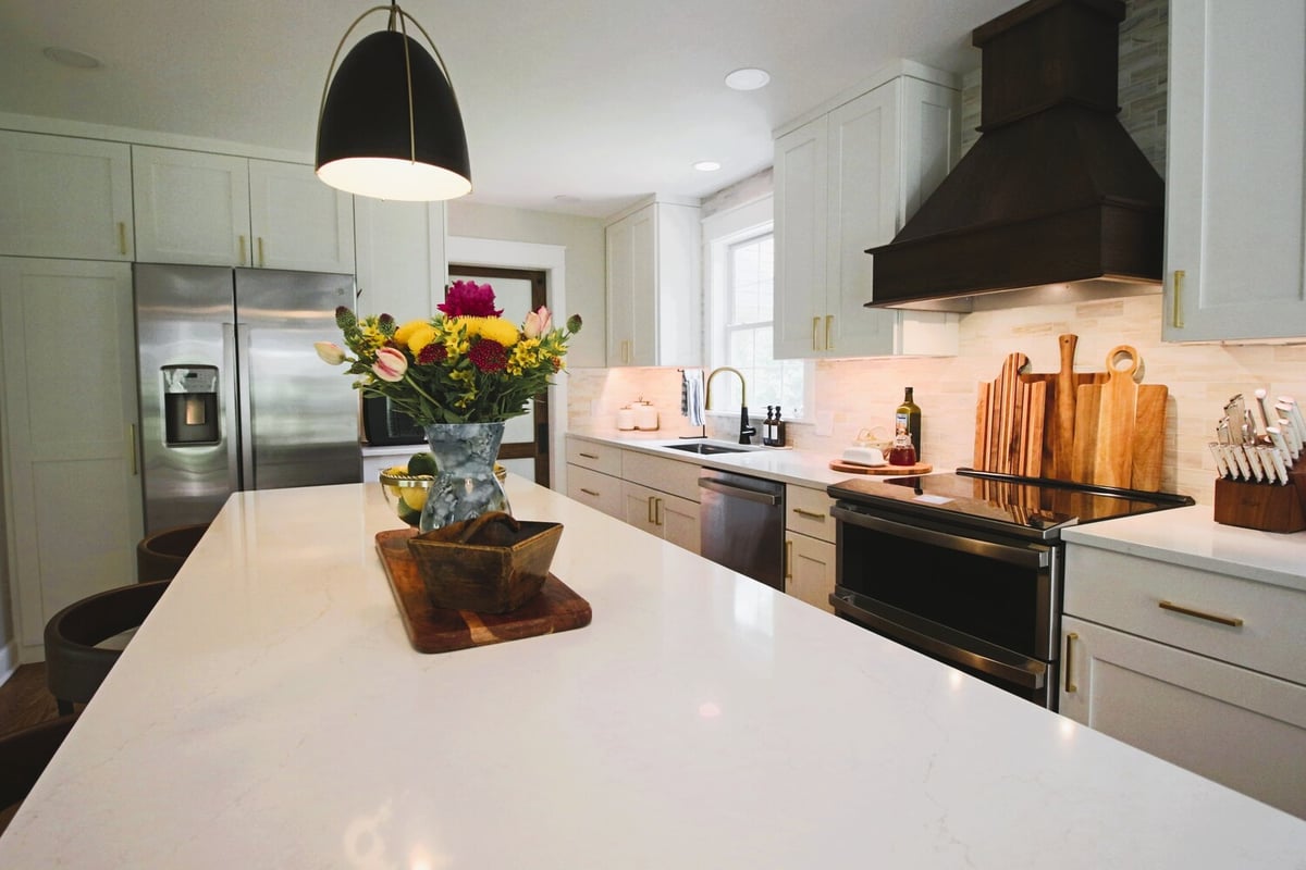 Bright kitchen island with floral centerpiece and prep space in Ross Construction custom home in Wausau, WI.