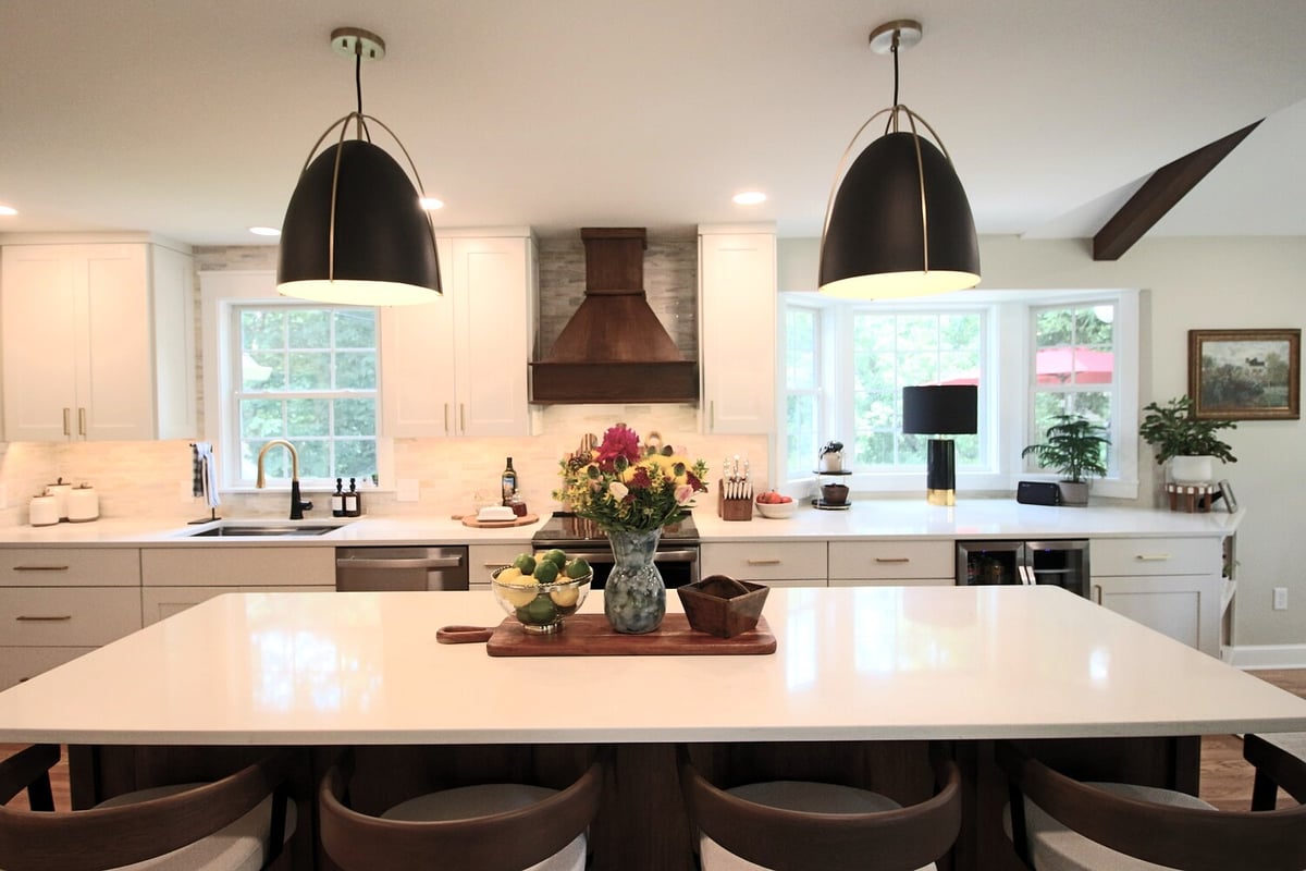 Dual pendant lights over kitchen island in bright custom kitchen by Ross Construction in Rib Mountain, WI.