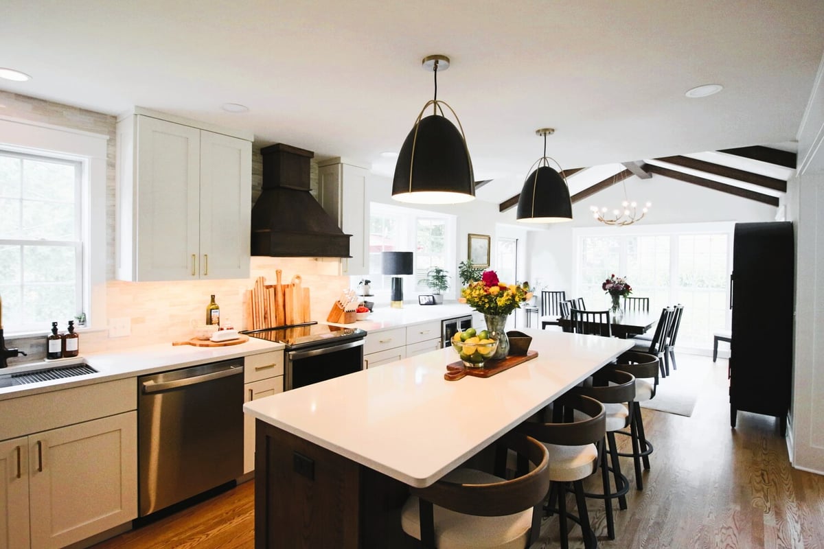 Full view of open-concept kitchen and dining room with vaulted ceiling in Ross Construction custom home in Edgar, WI.