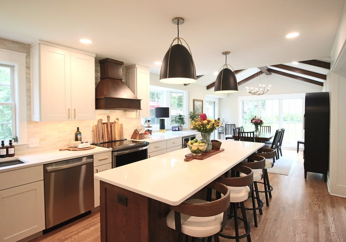 Kitchen island and dining area with vaulted ceiling and exposed beams by Ross Construction in Wausau, WI.