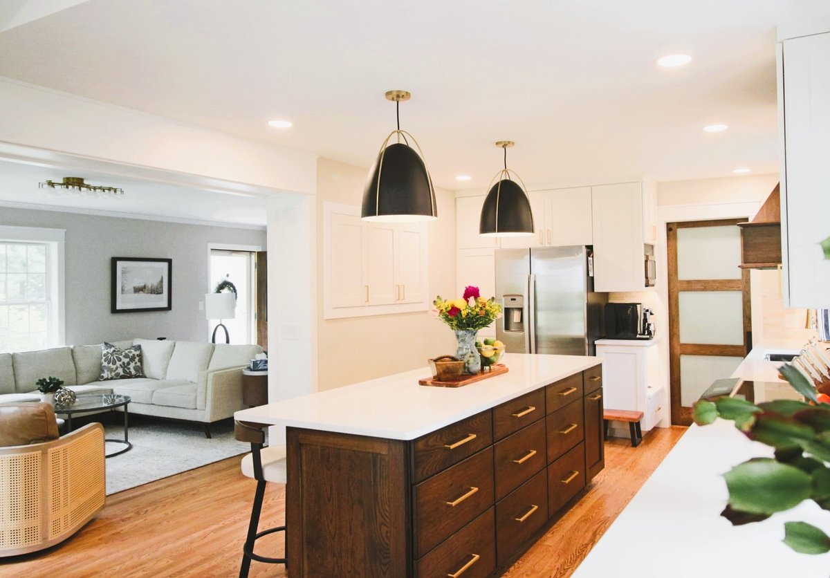 Kitchen island and living room transition with pendant lighting in Ross Construction custom home in Wausau, WI.