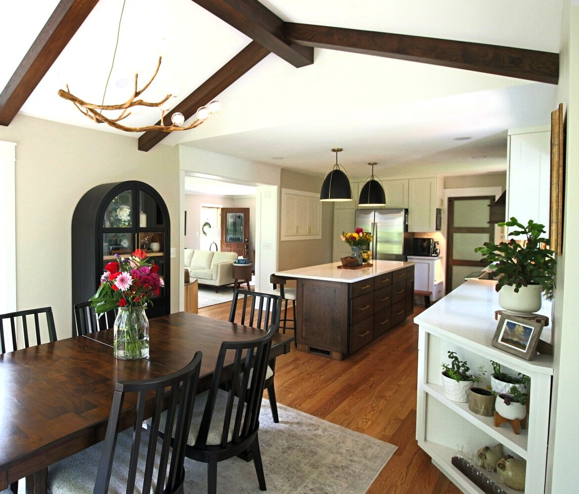 Transitional kitchen design with island and adjacent dining space in Ross Construction custom home in Lake Dubay, WI.