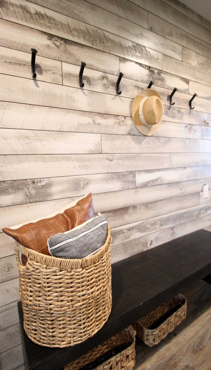 Custom mudroom in Edgar, WI home by Ross Construction with built-in bench and woven baskets.