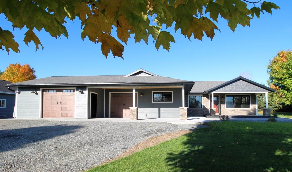 Exterior view of custom home built by Ross Construction in Marathon, WI with dual garages and modern finishes.