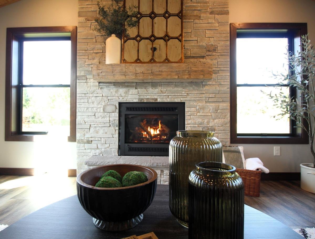Fireplace centerpiece with vases in custom home by Ross Construction in Lake Dubay, WI.