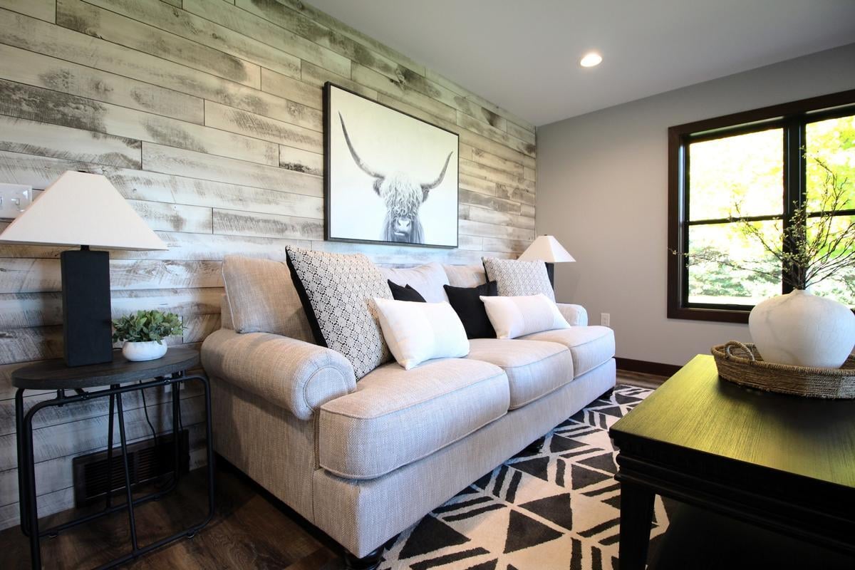 Living room wall detail with taupe sofa in Wausau, WI custom home by Ross Construction.