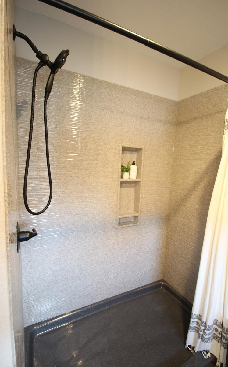 Modern shower with built-in niche in Lake Dubay, WI custom bathroom by Ross Construction.