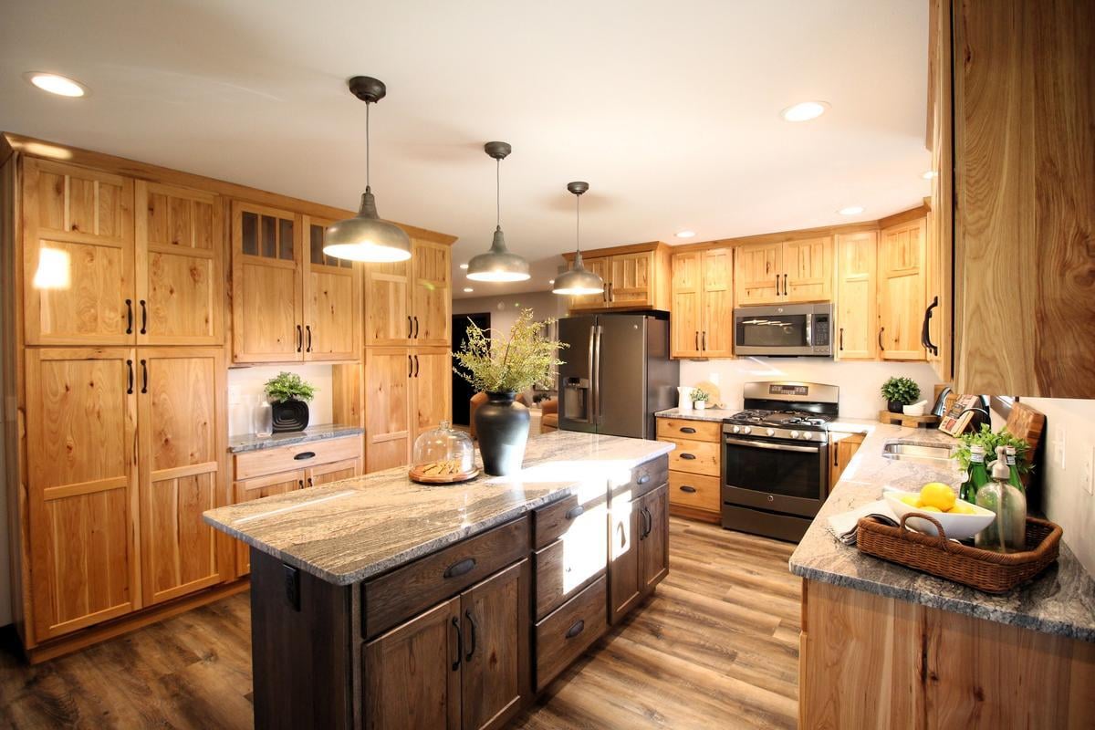 Natural wood custom kitchen in Lake Dubay, WI home built by Ross Construction with pendant lighting and island.