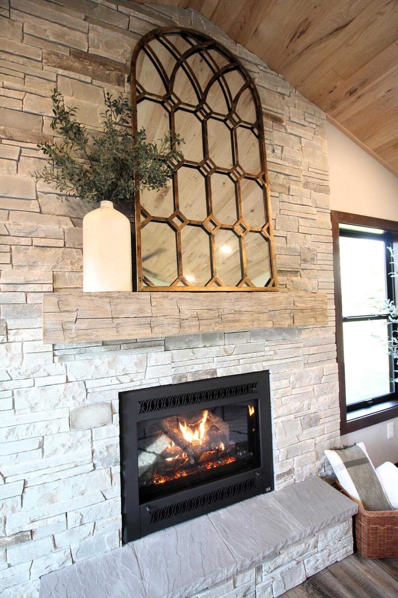 Stone fireplace with mirror in custom home by Ross Construction in Rib Mountain, WI.