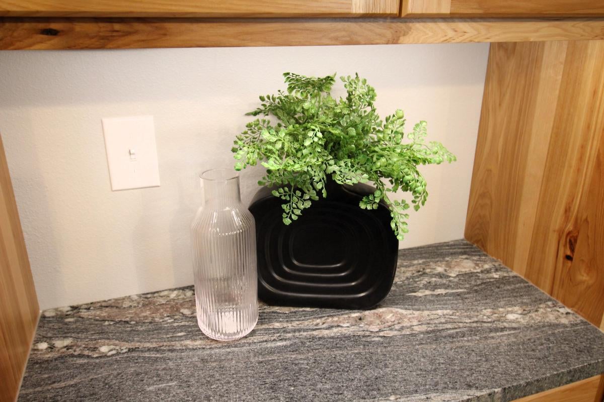 Styled kitchen counter in Lake Dubay, WI custom home by Ross Construction with plant decor.