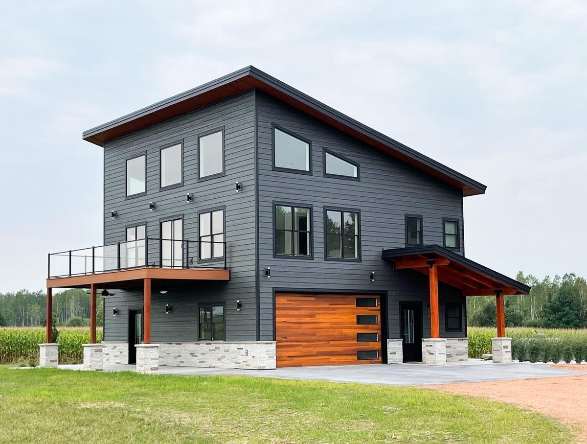 Custom modern home with mixed siding and large windows built by Ross Construction in Wisconsin.