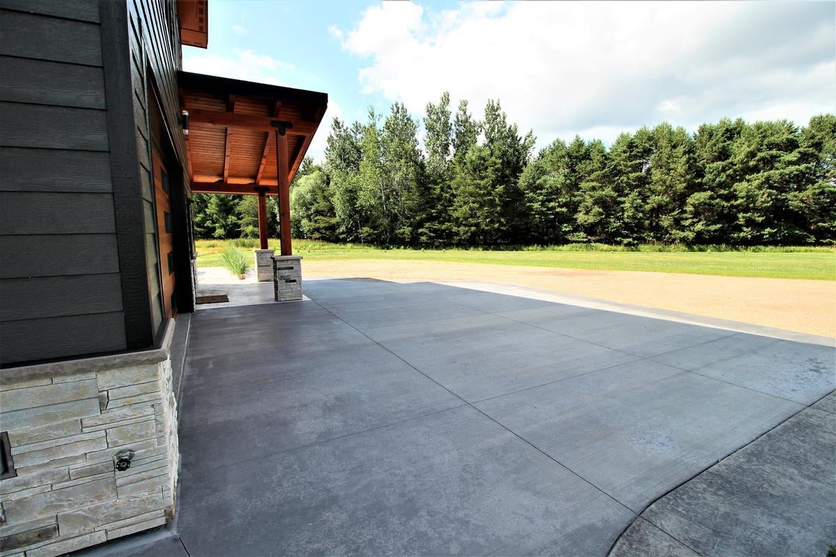 Expansive concrete driveway and front view of a custom home in Wausau, WI by Ross Construction.