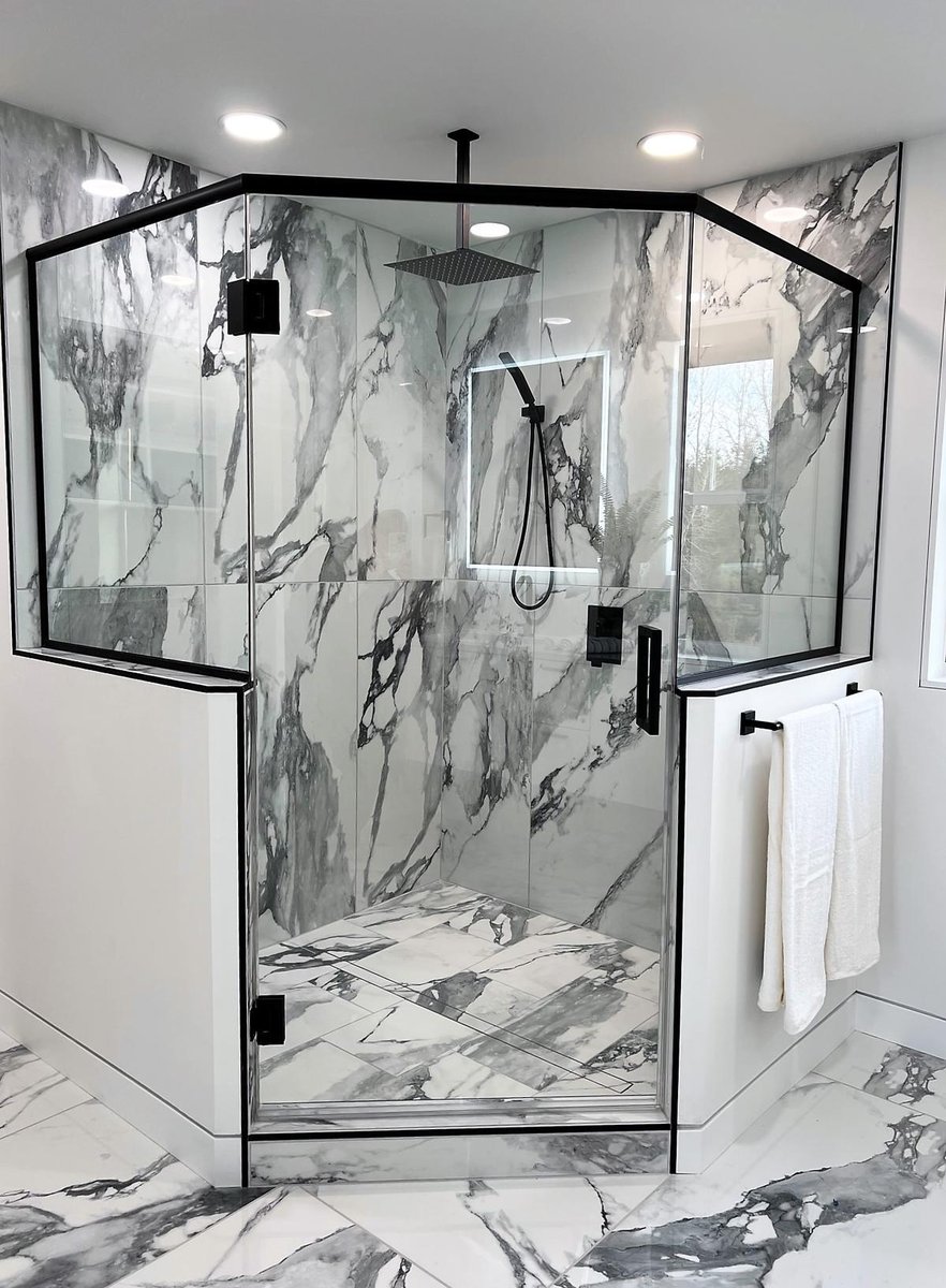 Luxury glass walk-in shower with black fixtures in Ross Construction custom home in Wisconsin.