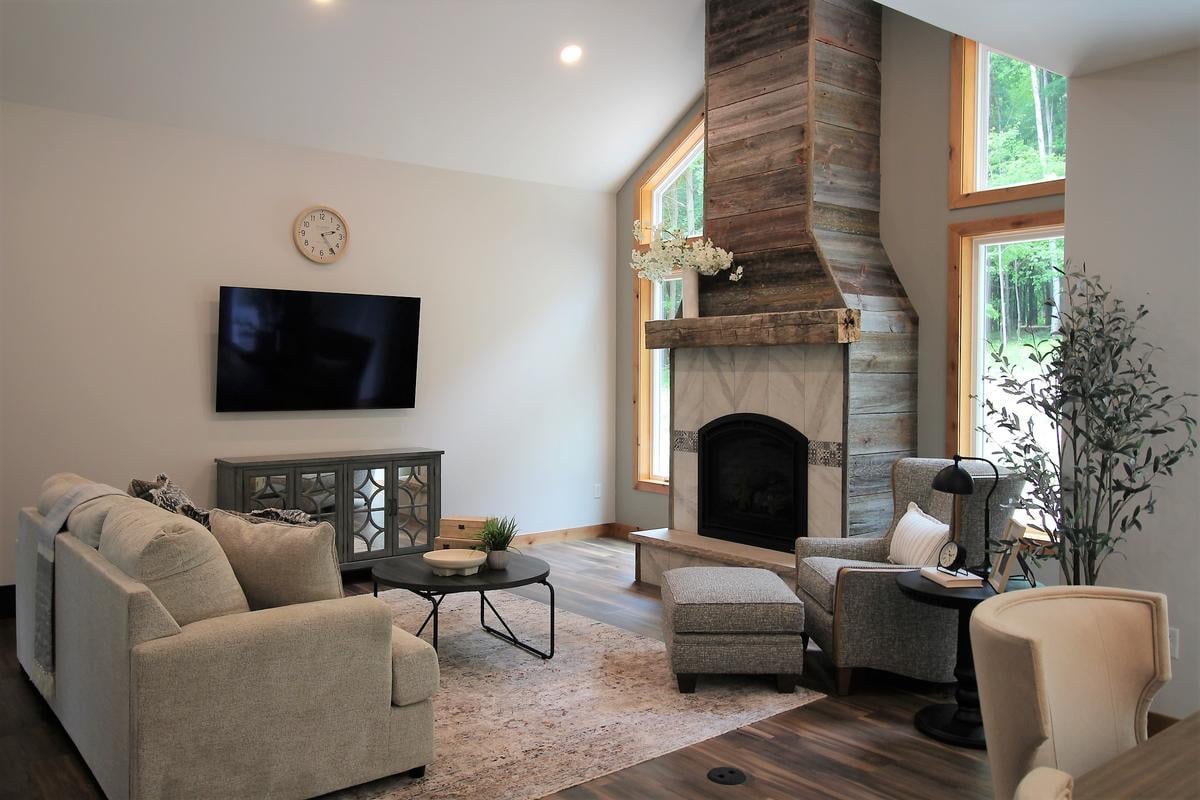 Cozy living room with fireplace and modern TV setup in a Rib Mountain, WI home by Ross Construction.