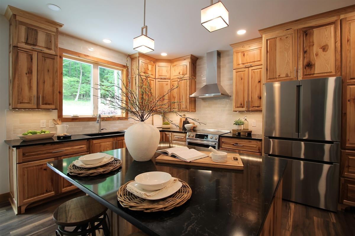 Rustic kitchen design with center island and stainless steel appliances by Ross Construction in Rib Mountain, WI.