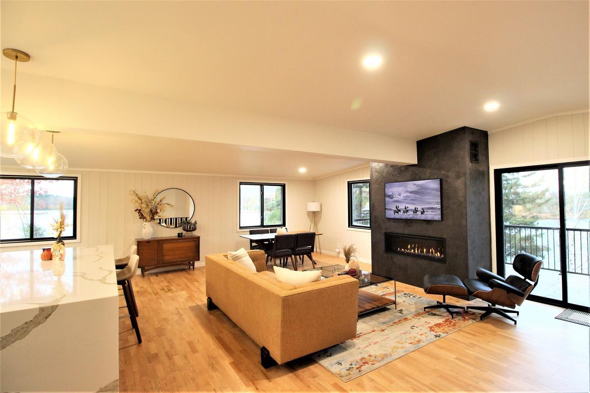 Ross Construction open living room and dining area with lake views in Rib Mountain, WI custom home.