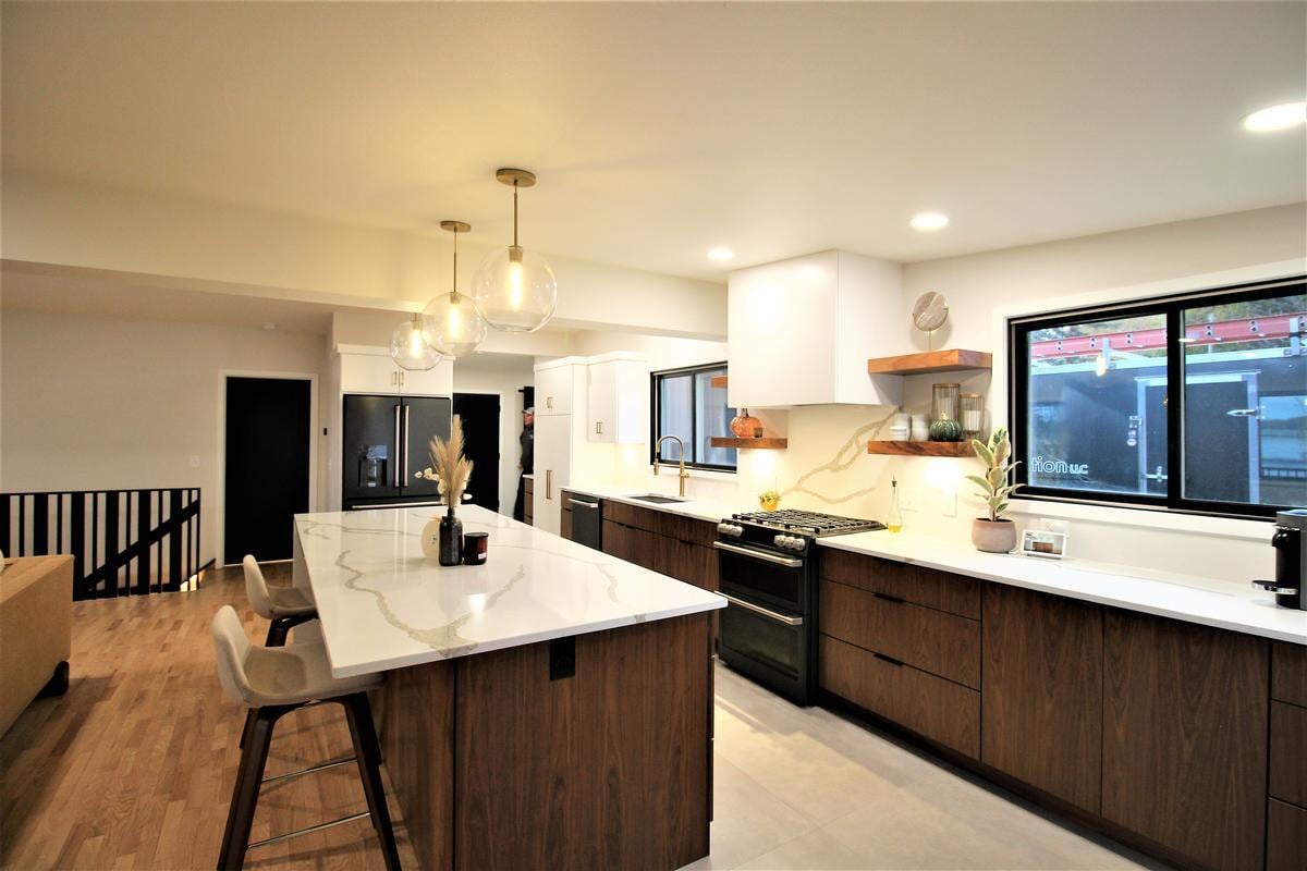 Wide-angle kitchen view featuring island lighting and modern cabinetry in Ross Construction’s Marathon custom home.