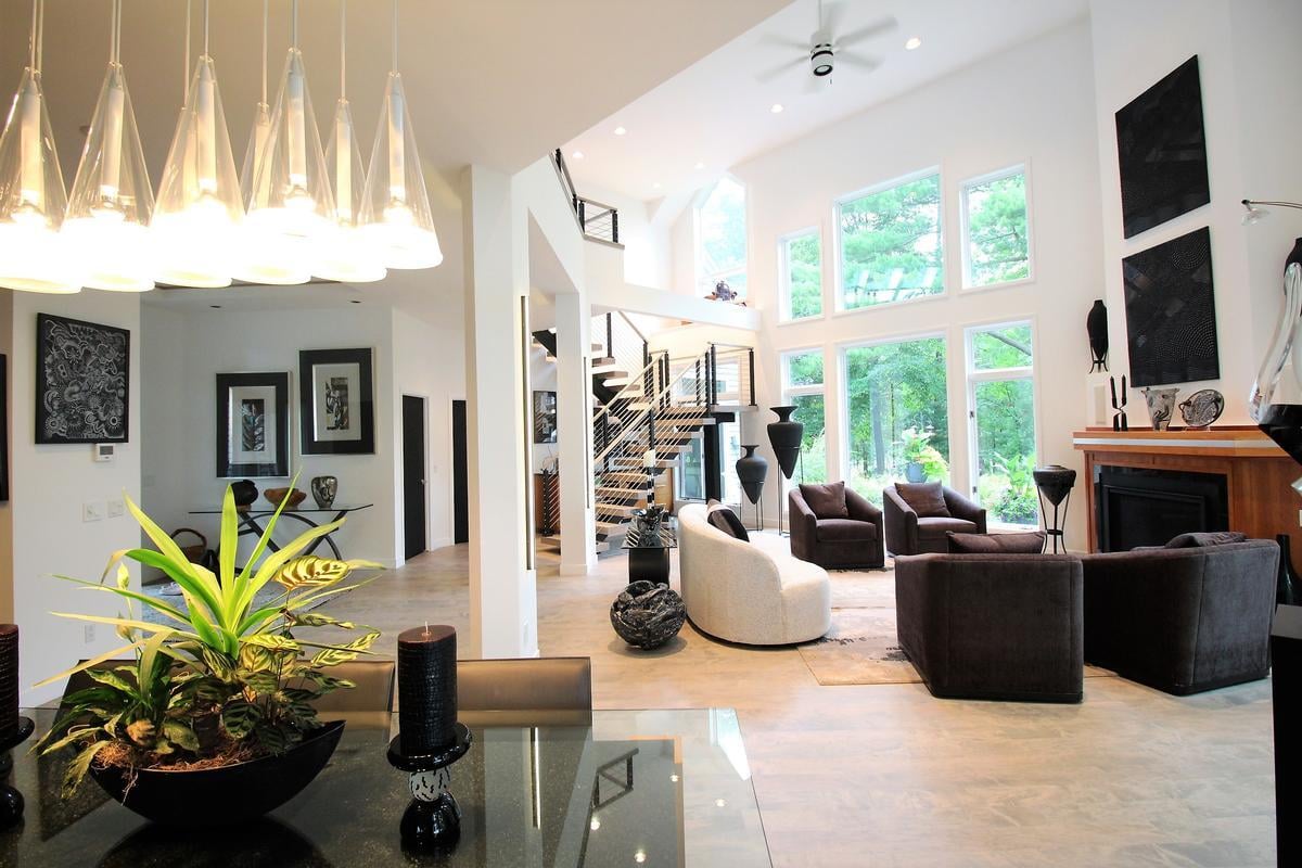 Bright dining and living space with modern chandelier in Marathon custom home by Ross Construction.