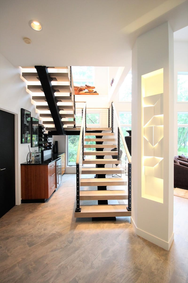 Elegant entryway and modern staircase in Marathon, WI custom home by Ross Construction.