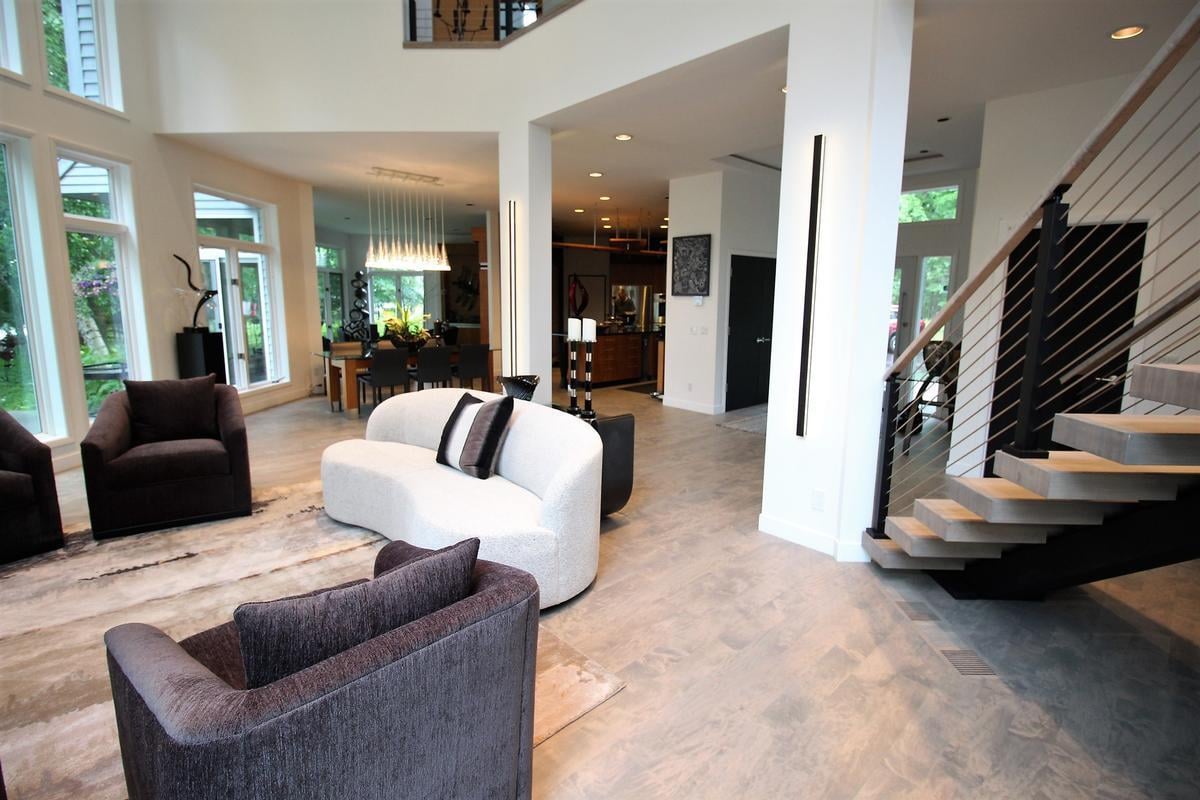 Ross Construction-designed open floor plan with staircase and lounge seating in Marathon custom home.