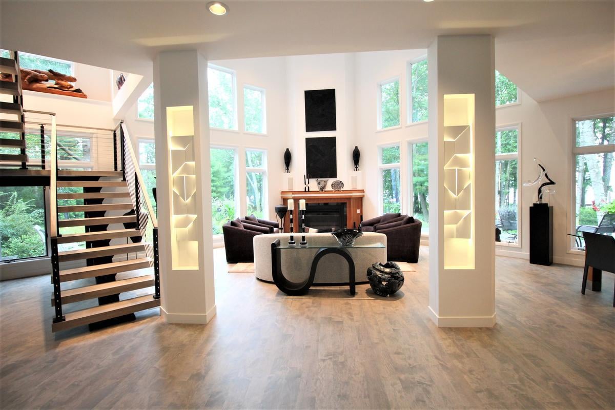 Stunning custom home great room with staircase and loft in Lake Dubay by Ross Construction.