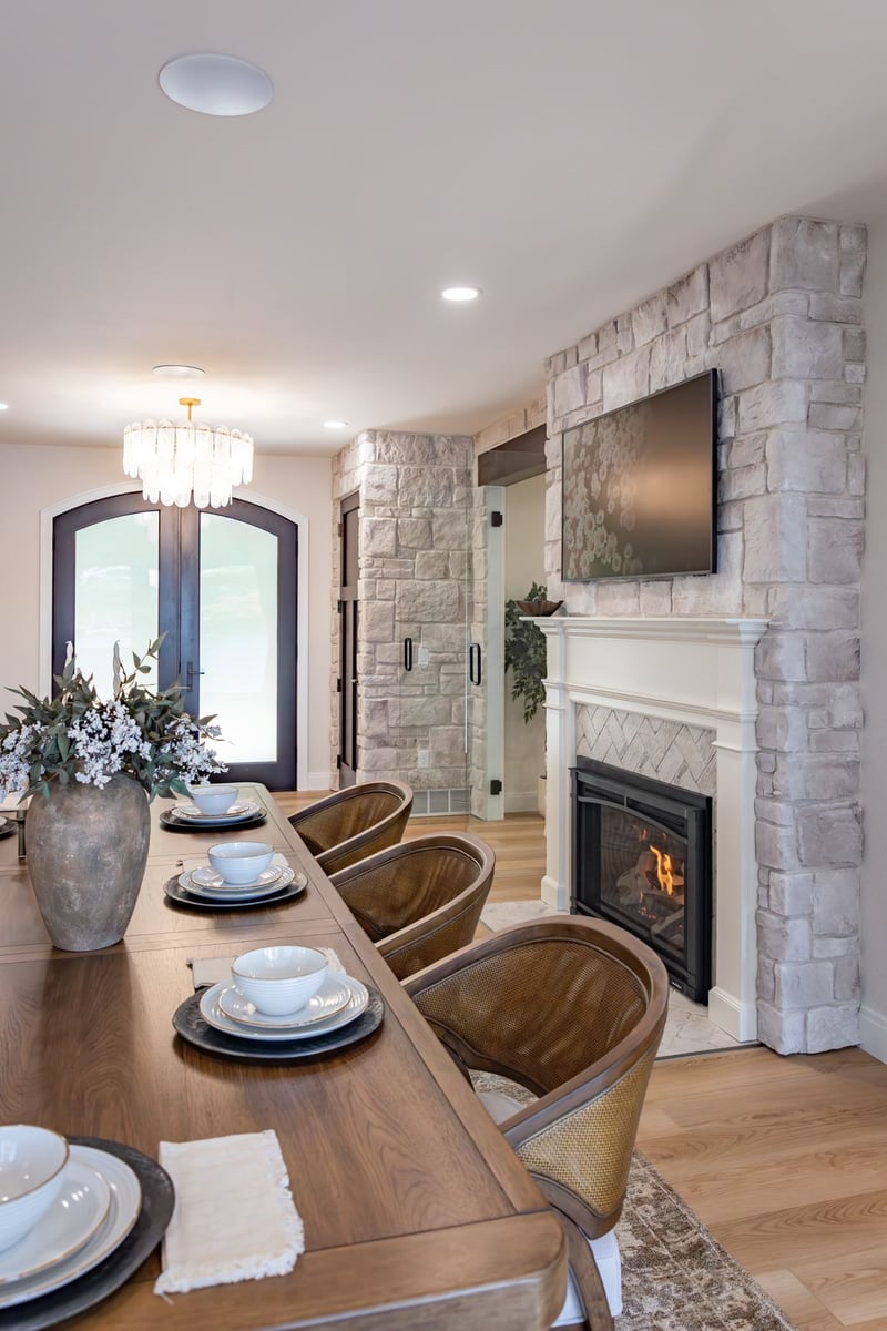 whole home remodel dining room cane chairs and stone fireplace vertical view minocqua wi