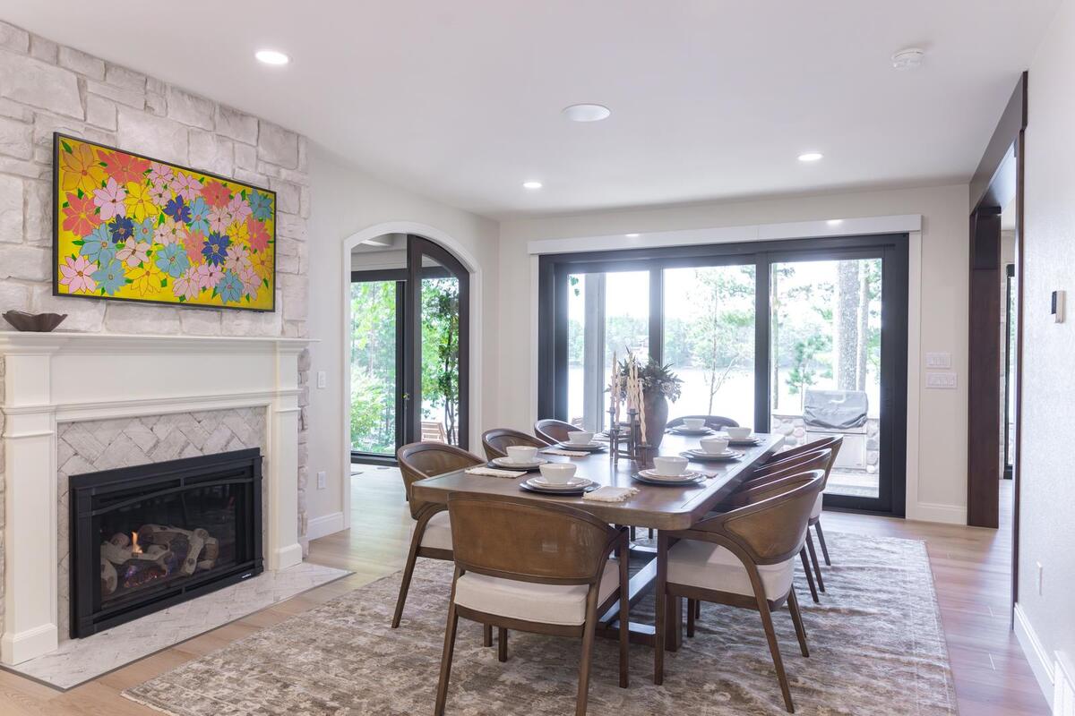 whole home remodel dining room with stone fireplace and floral artwork minocqua wi