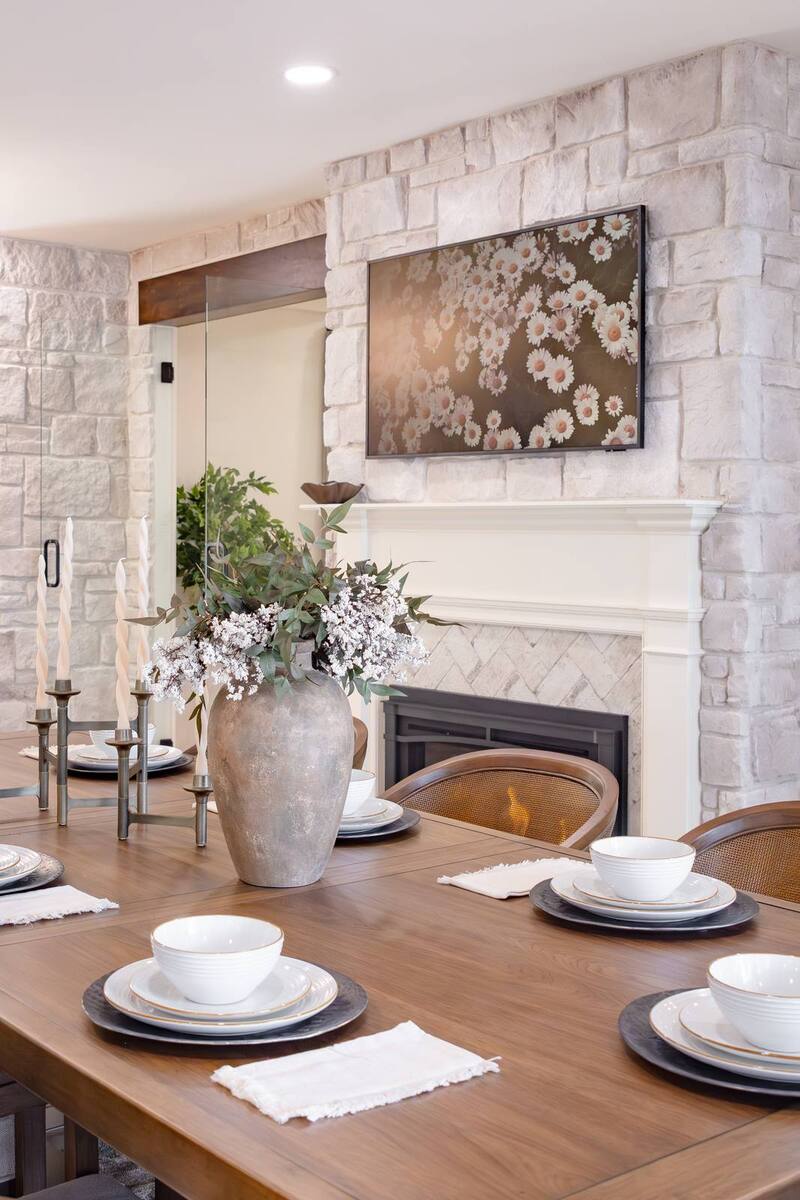 whole home remodel dining table place settings with stone fireplace close view minocqua wi