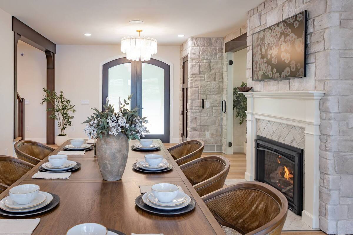 whole home remodel dining table view to foyer and stone fireplace minocqua wi