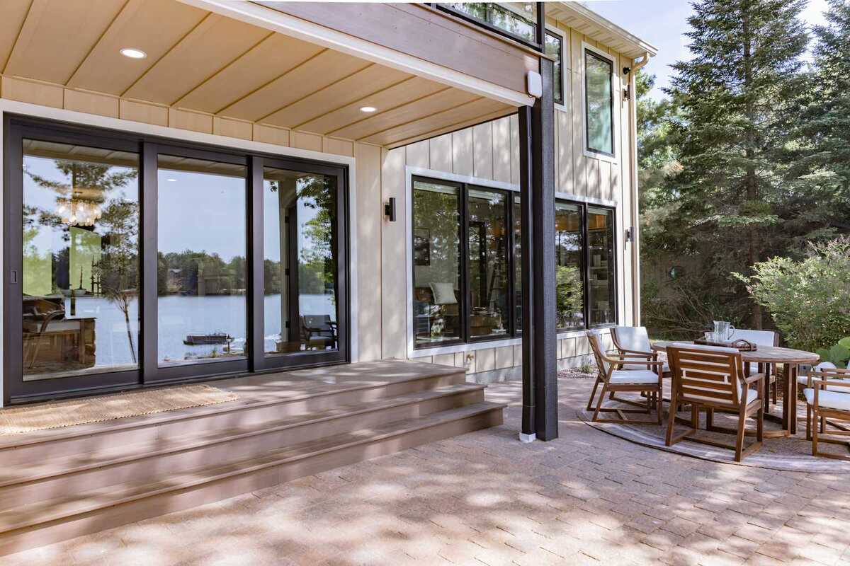 whole home remodel exterior covered lakeside patio wide view minocqua wi