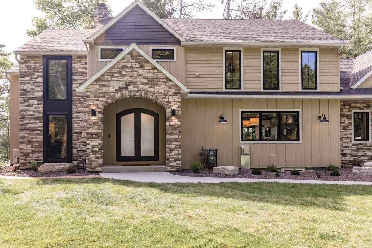 whole-home-remodel-exterior-front-entry-with-arched-double-doors-minocqua-wi