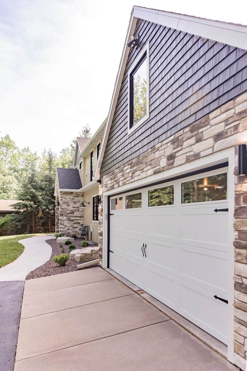 whole home remodel exterior garage with carriage doors and stone minocqua wi